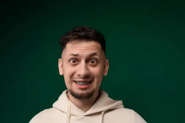 Man Wearing Hoodie Playfully Making Silly Expression Contorting His Face — Stock Photo, Image