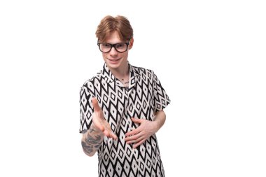 young surprised caucasian ginger man with a tattoo on his arms dressed in a black and white shirt feels annoyed. clipart