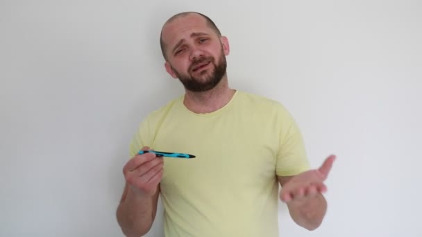 Casually Dressed Man Beard Standing White Background Indoors Holding Blue — Stock Video