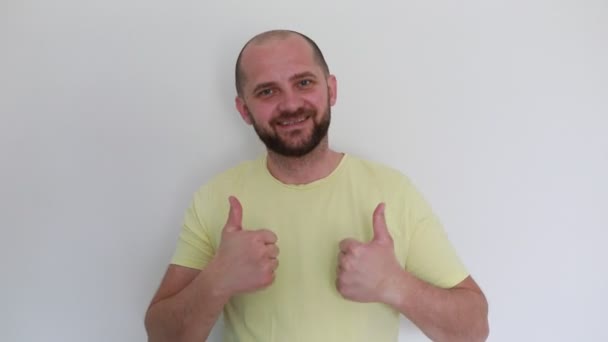 Cheerful Bald Man Wearing Yellow Shirt Stands Plain White Background — Stock Video
