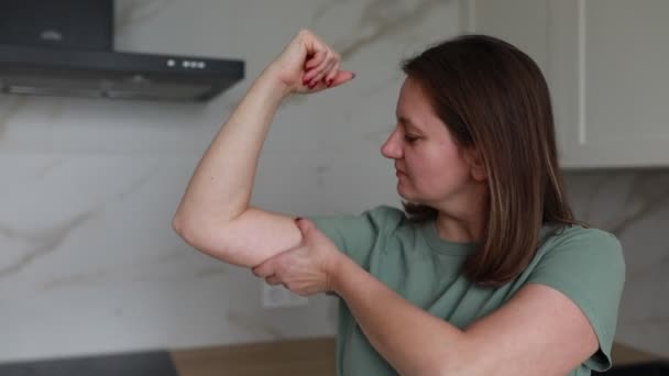 Confident Midlife Woman Proudly Flexes Her Bicep Muscle While Standing — Stock Video