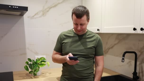 Man Seen Standing Kitchen Holding Remote Control Looking Device His — Stock Video
