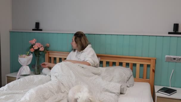 Una Mujer Despierta Del Sueño Revolviendo Lentamente Dormitorio Calurosamente Iluminado — Vídeos de Stock