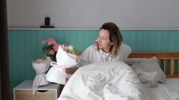 Woman Wakes Sits Cozy Bed Surrounded Soft Pillows Vase Fresh — Stock Video