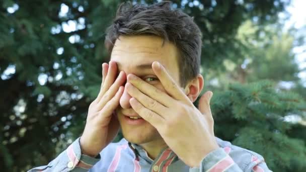 Smiling Young Man His Hands Playfully Covering His Face Engaged — Stock Video