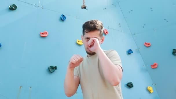 Man Stands Confidently Front Challenging Climbing Wall Observes Different Holds — ストック動画