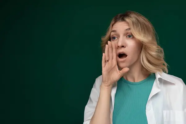 stock image A woman with a surprised expression on her face, her eyes wide open and mouth slightly agape. Her eyebrows are raised, indicating shock or astonishment.