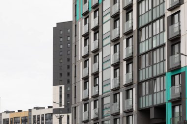 Konut seçeneklerinin çeşitliliğini ve kiracılar ve ev sahipleri için emlak sigortasının önemini gözler önüne seren uzun apartman daireleri bir konut mahallesinde duruyor..