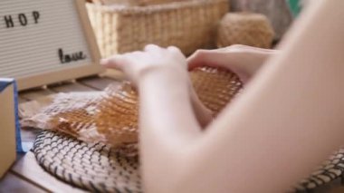 Eco vendor go green packaging parcel carton box in net zero waste store asian seller retail shop. Earth care day small SME owner asia people wrap reuse brown paper pack gift reduce plastic free order.
