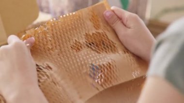Eco vendor go green packaging parcel carton box in net zero waste store asian seller retail shop. Earth care day small SME owner asia people wrap reuse brown paper pack gift reduce plastic free order.
