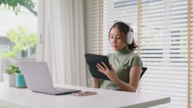 Taking a break work relax easy listen music joy sing a song at cozy home good time life balance remote WFH job. Mental health care enjoy fun dance reduce stress relief in Gen Z asia people young woman