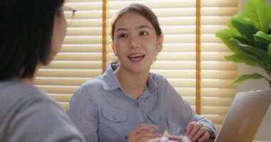 Smart Gen Z tech talent workforce young two people asia woman happy work at office. Small group asian leader team talk sharing idea give advice consult project plan in data engineer career job mentor.