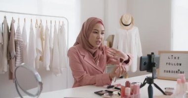 Islam youtuber arab influencer vlogger or beauty blogger live smile talk on social media vlog instagram. Show share selfie video sale online on small shop trendy job for asia people Gen Z young girl.