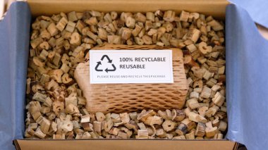 Net zero waste go green SME use eco friendly care sign plastic free symbol packaging carton box wrap paper in small shop retail store. Chva dried water hyacinth on desk reuse packing parcel supplies.