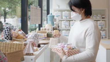 Asia vegan young adult woman carry bag happy buy eco bio goods glass jar pack on shelf. Trendy life SME startup store go green market refill bulk shop reduce climate change net zero free concept.