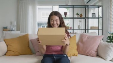 Asia people young woman smile love hug parcel box goods carton packaging happy joy awe face at home. Omni channel enjoy buy gift order postal at retail online shop store fast courier sending service.