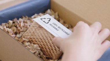 Eco vendor go green packaging parcel carton box in net zero waste store asian seller retail shop. Earth care day small SME owner asia people wrap reuse brown paper pack gift reduce plastic free order.