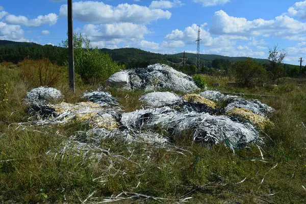 Dağların ortasında paketler için kullanılan plastik plastik kayış atığı gibi saman..