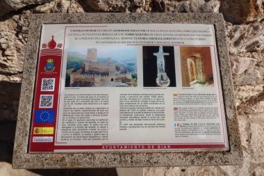 Biar, Alicante, Spain, January 14, 2023: Sign with information in the Arab Castle of Almohad origin from the 12th century in Biar, Alicante, Spain