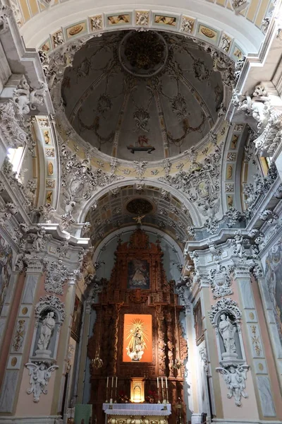 Biar, Alicante, Spain, January 14, 2023: Vertical view of the altar and dome of the Churrigueresque style Communion Chapel inside the church of Our Lady of the Assumption of Biar, Alicante, Spain