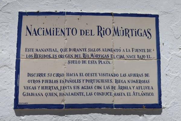 stock image Fuenteheridos, Huelva, Spain, April 26, 2023: Sign next to the famous fountain of the twelve pipes where the Murtigas river is born in the square of Fuenteheridos, Huelva, Spain