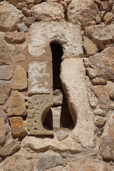Villena, Alicante, Spain, March 6, 2024: Loophole in one of the walls in the medieval castle of Arab origin of Atalaya. Villena, Alicante, Spain