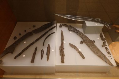 Rojales, Alicante, Spain, October 28, 2024: Display cases with knives from the Iron Age in the Paleontological Archaeological Museum of Rojales, Alicante, Spain clipart