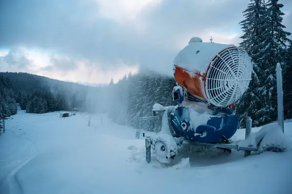 Kış dağlarında kar püskürten kar topları kar yağdıran makineler..