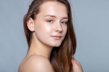 Parlak güzellik, cilt bakımının tadını çıkaran genç bir kadının bu görüntüsünde parlıyor. Güzellik başyazıları ve sağlık siteleri için ideal.