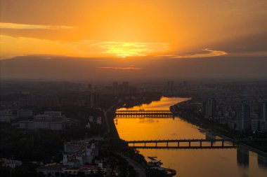 Suizhou Hubei üzerinde altın gün batımı Çin şehri ufuk çizgisi ve nehir.