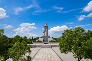 Çin 'in Suizhou kentindeki açık mavi gökyüzünün altındaki yeşil ağaçların arasında gururla duran büyük bir taş anıt..