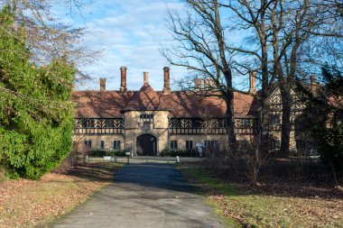 exterior view of Schloss Cecilienhof, showcasing its Tudor-style architecture and beautiful surroundings. clipart