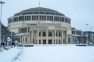 The centennial gala in the snow at Wroclaw showcases a stunning winter celebration, where guests enjoy the festive atmosphere against a backdrop of beautiful snow-covered surroundings. clipart