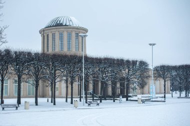 The centennial gala in the snow at Wroclaw showcases a stunning winter celebration, where guests enjoy the festive atmosphere against a backdrop of beautiful snow-covered surroundings. clipart