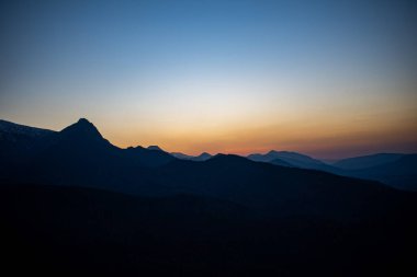 Polonya 'nın Zakopane kentindeki Kopieniec Dağı' nın tepesinde gün batımı, Tatra Dağları 'nın üzerine sıcak bir ışık saçıyor. Canlı renkleri ve nefes kesici manzaralarıyla doğa severleri büyüleyen çarpıcı bir manzara yaratıyor..