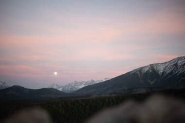 The sunset atop Mount Kopieniec in Zakopane, Poland, casts a warm glow over the Tatra Mountains, creating a stunning landscape that captivates nature lovers with its vibrant colors and breathtaking views. clipart