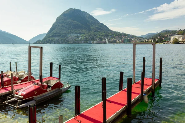 stock image Red pedal boats ready for renting - summer sunny day in Lake Lugano, Switzerland