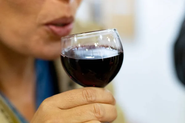 Wine. Right moment where a woman drinks a glass of red wine. Horizontal photography.
