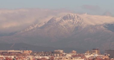 Snow. Madrid. Sierra de Guadarrama. White mountain full of white snow. Winter concept. Video. Madrid video. Time Lapse of a mountain with the clouds passing over the snow covered top.