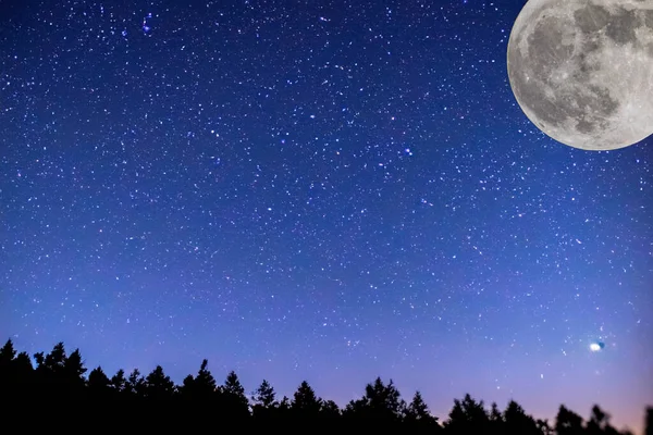 Full moon. Stars. super full moon. Full moon with the background full of stars in the galaxy. Horizontal photography. The Galaxy. With silhouette of trees. Strawberry moon. Photo. 4 June 2023.