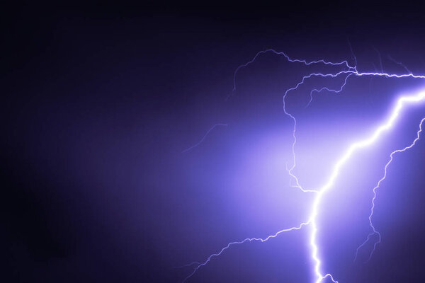 Ray. Lightning storm. Lightning bolt storm. Fork lightning striking. Lightning thunderstorm flash over the night sky. Concept on topic weather, cataclysms (hurricane, Typhoon, tornado, storm).