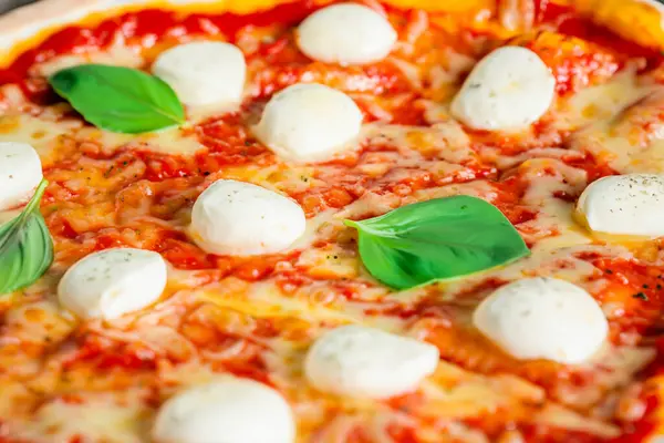 Pizza. Homemade pizza. Delicious pizza. Freshly made Italian margherita pizza with buffalo mozzarella and basil. Pizza with cheese, tomato sauce. Wood oven. World Pizza Day. February 9. 2024.