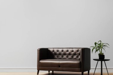 Oturma odası. Boş duvar arkası deri koltuklu oturma odası. Modern oturma odasının içinde siyah deri koltuk ve lamba var. Kanepesi ve sehpası olan modern oturma odası..
