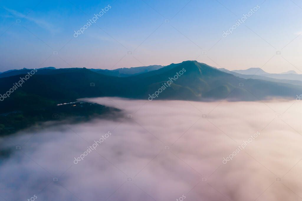 Fog. Surreal beautiful forest with fog. Aerial view. Beautiful sunrise above the forest with heavy fog. Mysterious forest in the fog.