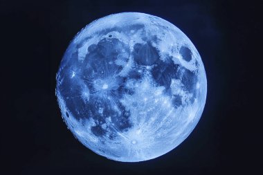 Blue Moon. Cold moon. Full moon. Super full moon. 15 December 2024. Super full moon with dark background. Moon. Supermoon. Blue super moon glowing with blue halo surrounded by small stars on black sky background.