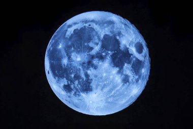 Blue Moon. Cold moon. Full moon. Super full moon. 15 December 2024. Super full moon with dark background. Moon. Supermoon. Blue super moon glowing with blue halo surrounded by small stars on black sky background.