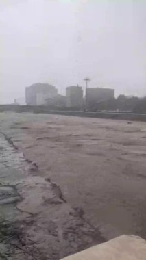 Flood. Severe flooding. River floods overflow riverbed trees under water debris slow motion. Water flow of a stream during a rain period carrying a lot of dirty water. 2025. Ireland. Eowyn.