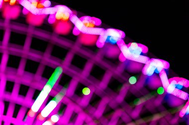 Ferris wheel. Noria. Christmas lights in Vigo, Pontevedra. Christmas decorations. Tourists strolling through its streets. Ferris wheel in the dark showing neon colors. VIGO. SPAIN. 23 December 2024. clipart