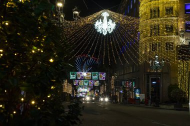 Christmas. Light. Christmas lights through the streets of Vigo. Decorating streets of the city. Fir tree with Christmas lights. Christmas ball. On. VIGO. SPAIN. 23 December 2024. clipart