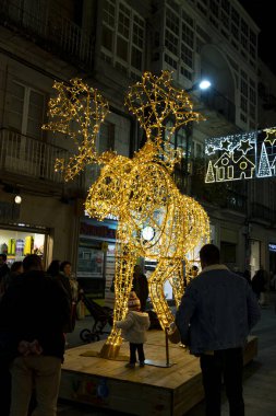 Christmas. Light. Christmas lights through the streets of Vigo. Decorating streets of the city. Fir tree with Christmas lights. Light tree. On. VIGO. SPAIN. 23 December 2024. clipart